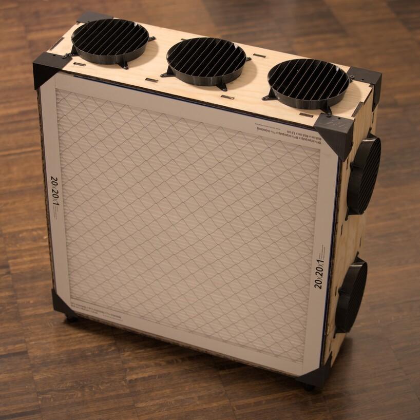a wooden box with plastic corners, holding merv13 filters in place, with 5 fans visible on the edges