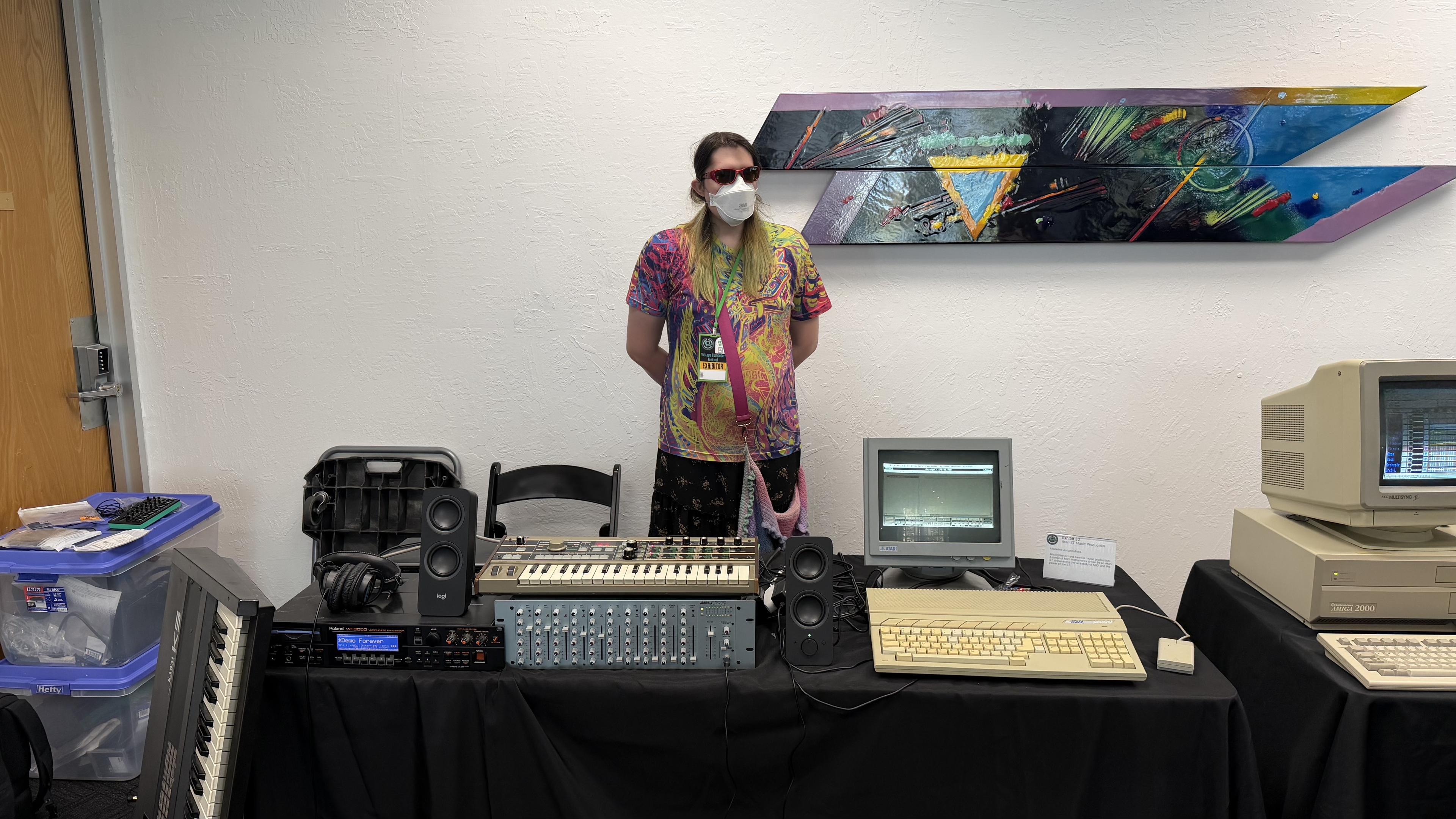 me, sunglasses, tie dye shirt, skirt, multiple synths and an atari st and mixer and monochrome monitor