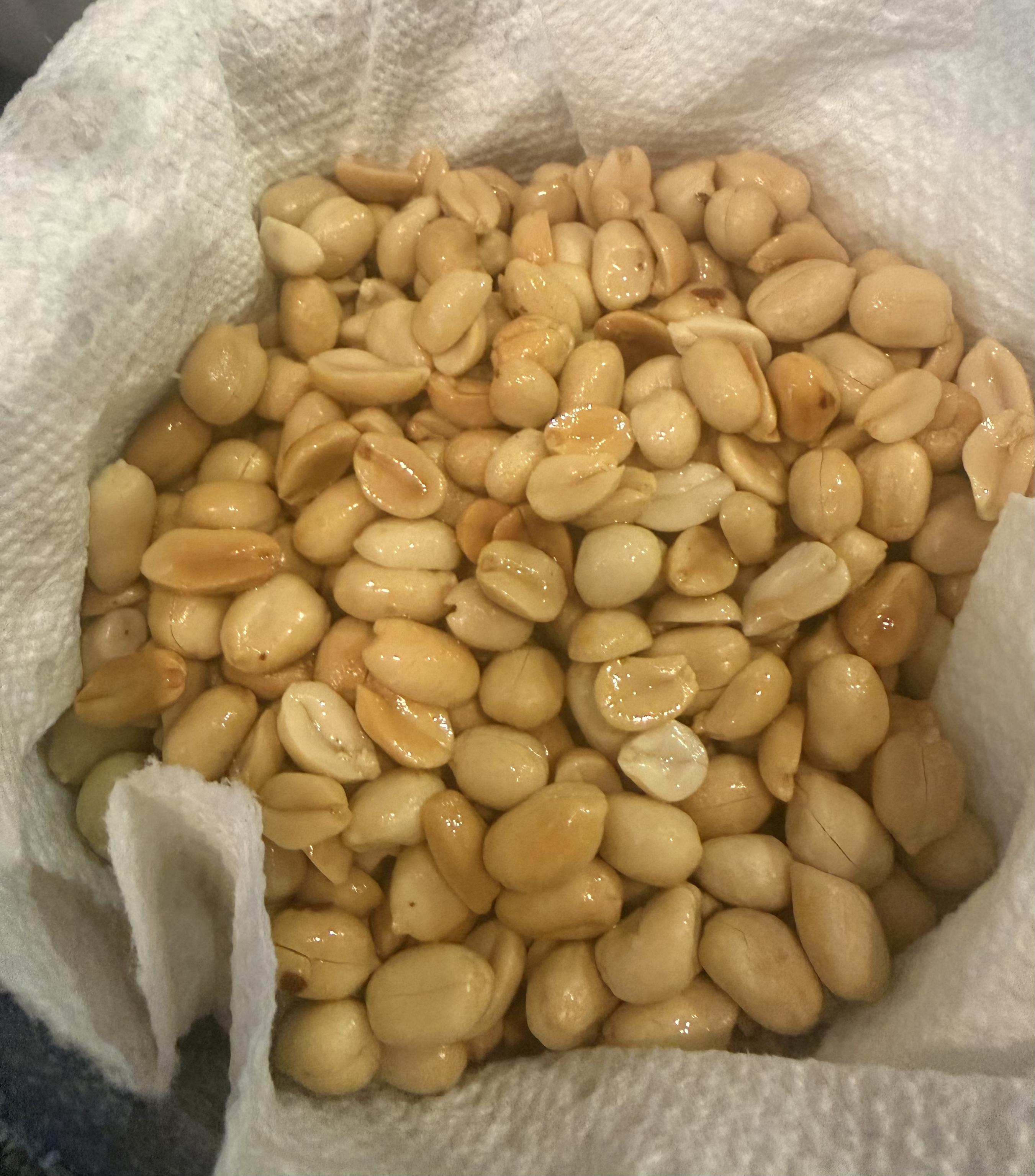 stir-fried peanuts in a bowl lined with paper towels